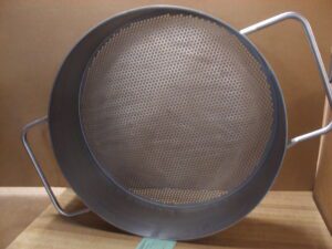 A metal perforated basket strainer for hydraulic systems.
